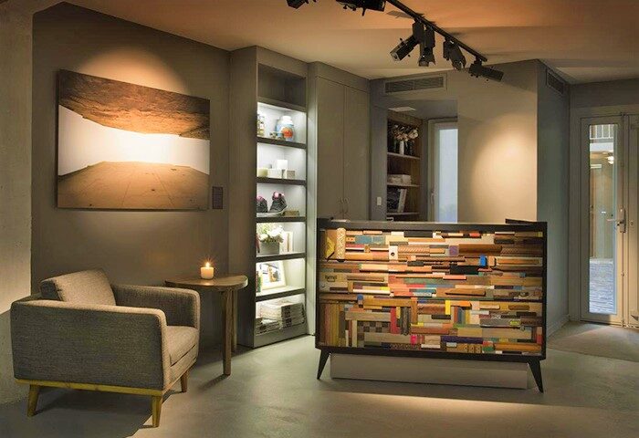 Hôtel Jules & Jim's lobby in Paris. Coolest gay hotel city centre features modern design, unique reception desk, art, and cozy armchair.