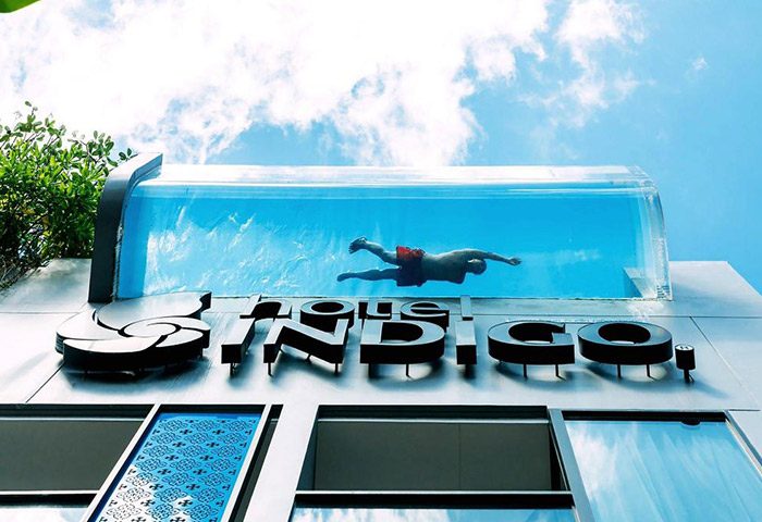 Hotel Indigo Phuket Patong rooftop pool. A man swims in the coolest rooftop pool at this gay-friendly Patong Beach hotel.