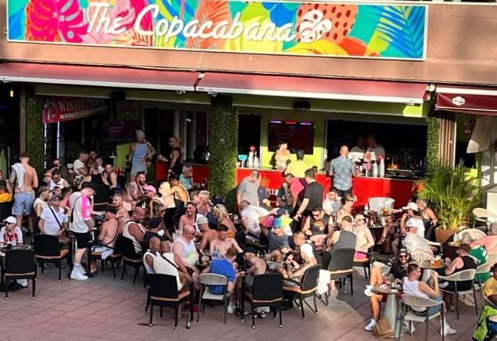 Copacabana Gay Bar in Gran Canaria. Outdoor seating area filled with gay men enjoying drinks. Popular gay travel destination.
