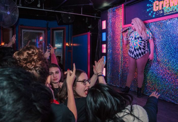 Drag queen performs at Crews & Tangos, a popular gay bar in Toronto. The audience cheers during the show. Gay travel advice.
