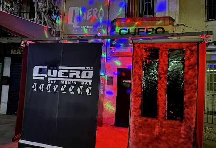 Cuero Cruising Club Torremolinos entrance. Gay men's bar with colorful lights. Nightlife destination in Torremolinos, Spain.