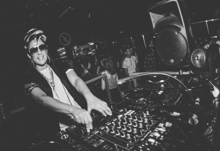 DLRO Live Gay Club in Madrid: DJ spinning music. Nightlife scene, part of the gay travel experience in Madrid. Black and white photo.