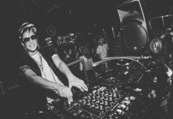 DLRO Live Gay Club in Madrid: DJ spinning music. Nightlife scene, part of the gay travel experience in Madrid. Black and white photo.
