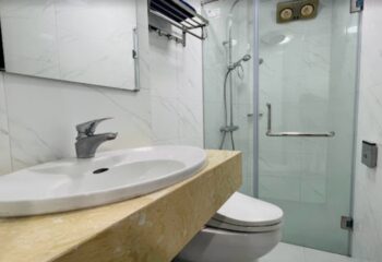 DaNi Spa Hanoi bathroom. Clean, modern design with white marble tiles, glass shower, and sleek fixtures. Gay travel advice for Hanoi, Vietnam.