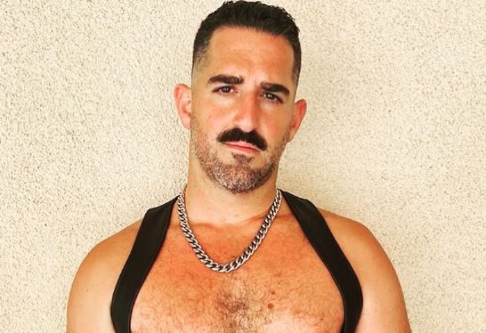 Daddy Big Hands: Man with mustache, chest hair, chain, and leather harness. Gay travel advice from Roy. Daddy-Big-Hands.jpg