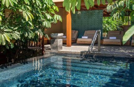 Delta Hotels by Marriott Riviera Nayarit All-Inclusive pool view. Relaxing gay travel destination with lounge chairs and lush greenery.