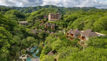 Delta Hotels by Marriott Riviera Nayarit All-Inclusive resort. Lush jungle setting with pools and thatched-roof buildings. Gay travel destination.