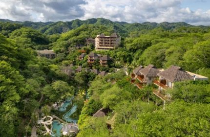 Delta Hotels by Marriott Riviera Nayarit All-Inclusive resort. Lush jungle setting with pools and thatched-roof buildings. Gay travel destination.