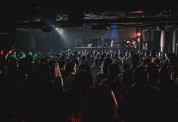 Crowd at City Hall gay club in Barcelona, a popular gay nightlife spot. People dancing, DJ on stage, disco ball.