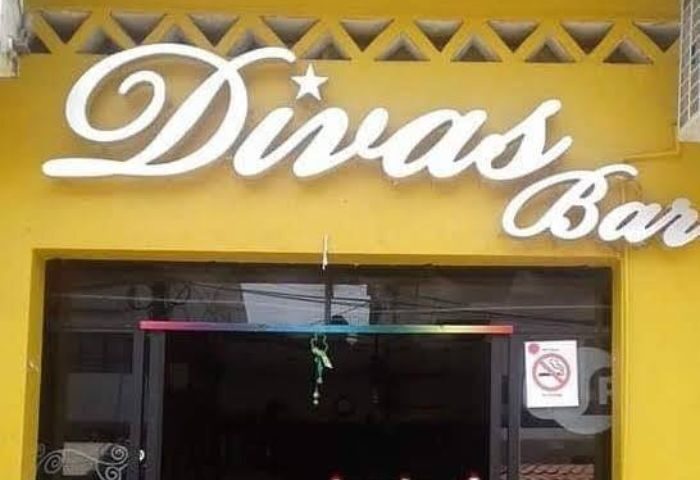 Divas Bar sign in Puerto Vallarta. Gay bar front view with rainbow flag colors. Gay travel destination. Nightlife spot.