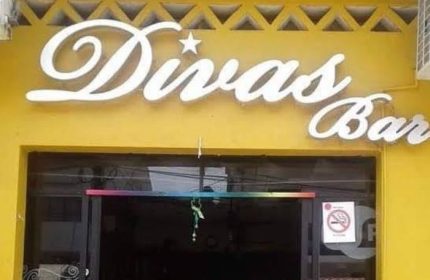 Divas Bar sign in Puerto Vallarta. Gay bar front view with rainbow flag colors. Gay travel destination. Nightlife spot.