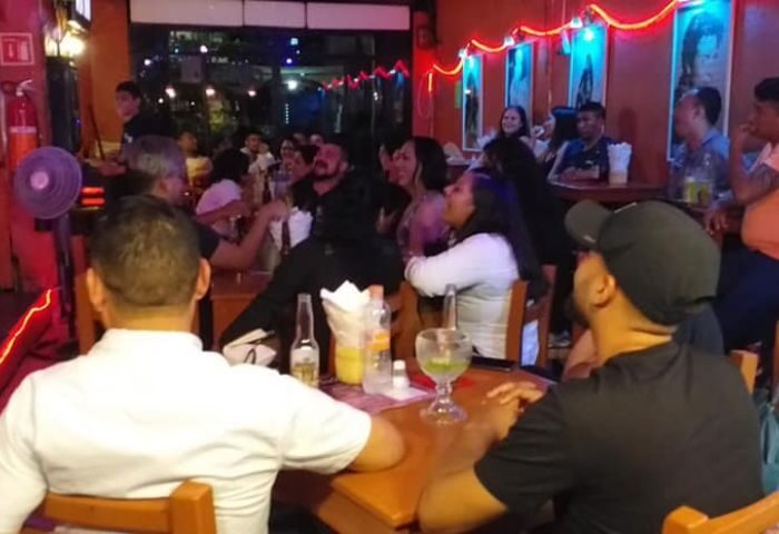 Diva's Gay Bar in Puerto Vallarta. Interior view of the bar with patrons seated at tables, enjoying drinks and conversation. Nightlife scene.
