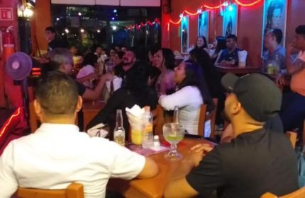 Diva's Gay Bar in Puerto Vallarta. Interior view of the bar with patrons seated at tables, enjoying drinks and conversation. Nightlife scene.
