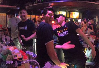Dragon Men gay bar in Tokyo. Happy hour scene with male dancers and bartenders. Nightlife at a popular gay bar. Travel advice.