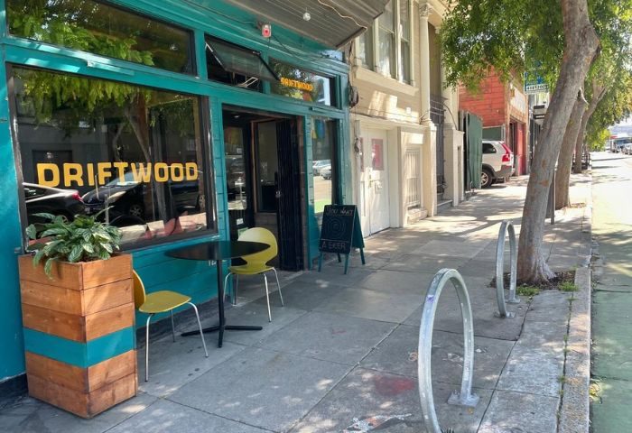 Driftwood Bar in San Francisco. Exterior view of the gay-friendly bar with tables and chairs outside. A popular spot for gay men travelers.
