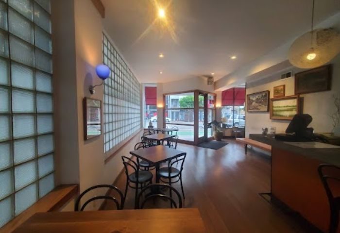 Interior of Driftwood Bar in San Francisco. Tables, chairs, and glass block wall. Gay travel advice for a welcoming bar.