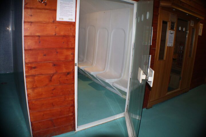 E15 Club gay sauna. Interior view of a sauna at E15 Club, a gay venue. Features wooden walls and seating for multiple people.