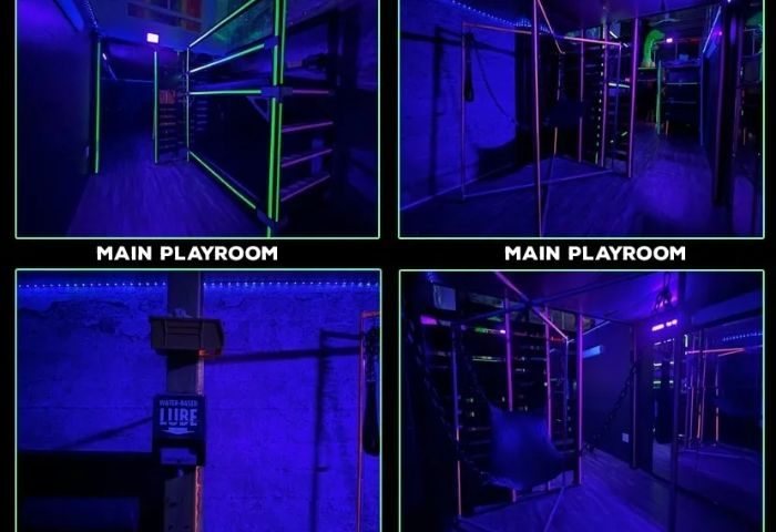Gay cruising in San Francisco: EROS main playroom. Dark room with neon lights, shelves, and a chair swing. Gay travel advice.