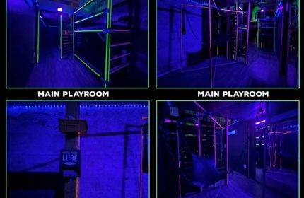 Gay cruising in San Francisco: EROS main playroom. Dark room with neon lights, shelves, and a chair swing. Gay travel advice.