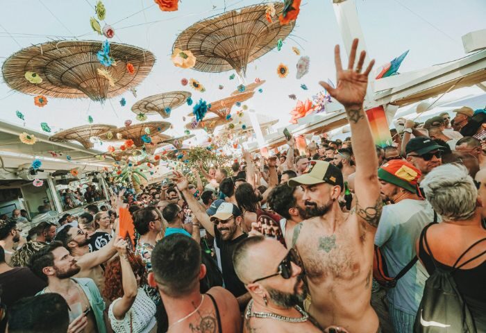 Gay beach party at Eden Beach Club, Torremolinos. Crowd of men enjoying the sun, music, and drinks at this popular gay bar.