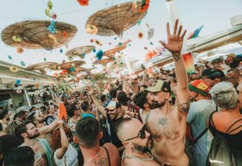 Gay beach party at Eden Beach Club, Torremolinos. Crowd of men enjoying the sun, music, and drinks at this popular gay bar.