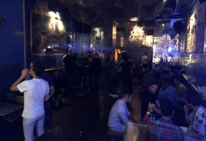 El Cangrejo, a gay bar in Barcelona's Eixample district. Interior view with patrons enjoying drinks, creating a lively, social atmosphere.