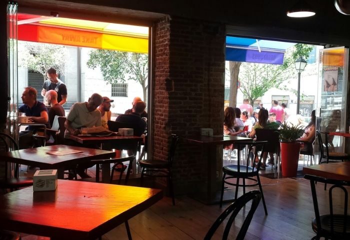 El Rincon Guay Gay Bar in Madrid: Interior view of the bar with patrons seated at tables, enjoying the ambiance and outdoor views.