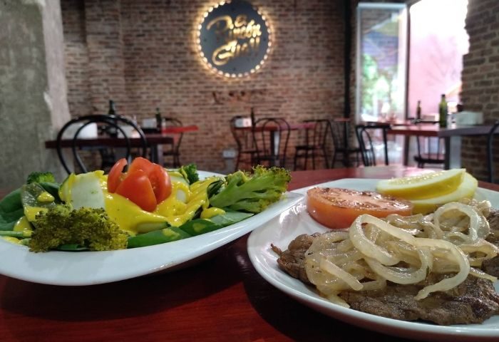 El Rincon Guay Gay Bar Madrid: Two plates of food at the gay-friendly restaurant. One with salad, the other with steak.
