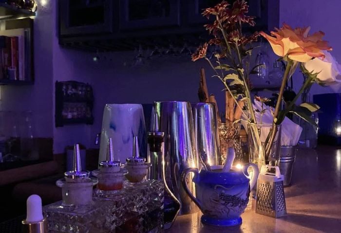 Elixir Mixology Bar in Puerto Vallarta. Gay bar scene with cocktail equipment, flowers, and a sugar bowl. Gay party & drag venue.