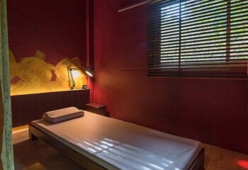Emerald Green Mens Club gay travel: Massage bed in Koh Samui. Interior of a spa or relaxation room for gay men's wellness.