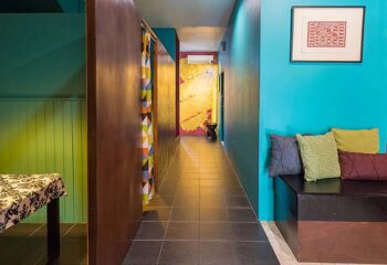Emerald Green Mens Club interior. Colorful hallway with seating area. Gay travel advice, relaxation space, men's club.