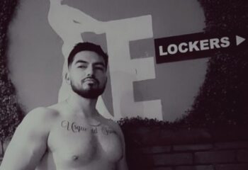 Shirtless man with tattoo at Entourage Las Vegas. Gay cruising spot near lockers. Las Vegas gay travel advice.