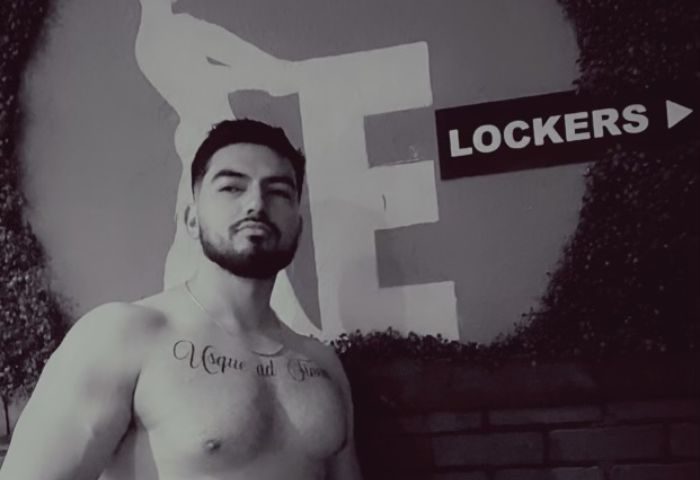 Shirtless man with tattoo at Entourage Las Vegas. Gay cruising spot near lockers. Las Vegas gay travel advice.
