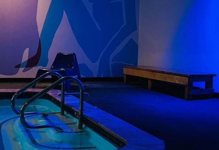 Entourage Las Vegas gay cruising: Pool, chair, and bench in a blue-lit room. Gay travel advice for men in Las Vegas.