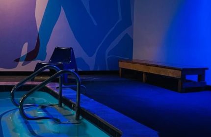 Entourage Las Vegas gay cruising: Pool, chair, and bench in a blue-lit room. Gay travel advice for men in Las Vegas.