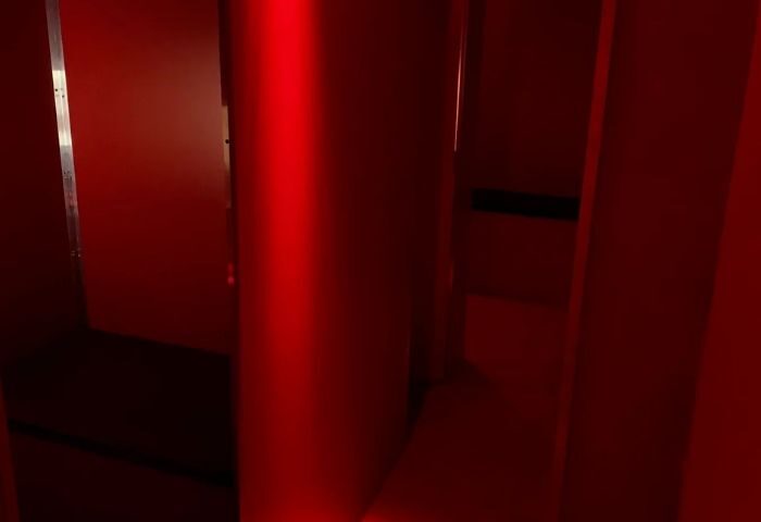 Interior of Erotic Palace, a gay cruise club in Barcelona. Red lighting, dark corners, and suggestive atmosphere for gay men's travel.