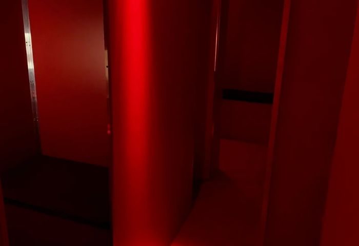 Interior of Erotic Palace, a gay cruise club in Barcelona. Red lighting, dark corners, and suggestive atmosphere for gay men's travel.