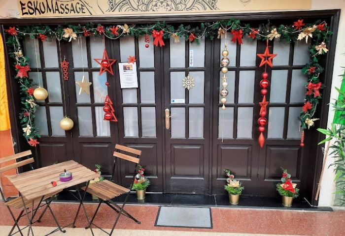 Esku-Massage Maspalomas door, Gran Canaria. Christmas decor, table, chairs. Gay massage for men in Maspalomas, Gran Canaria. Festive.