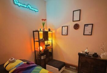 Eugenio Massage room in Barcelona. Gay massage with a rainbow flag blanket, certificates, and a Minion. Gay travel advice.