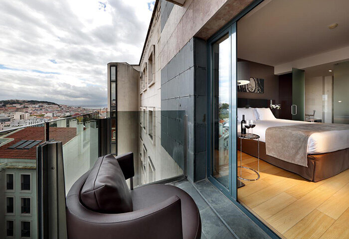 Eurostars Hotel das Letras, Lisbon. Balcony view from this luxury gay hotel near gay bars. Room with city view, wine, and comfortable chair.