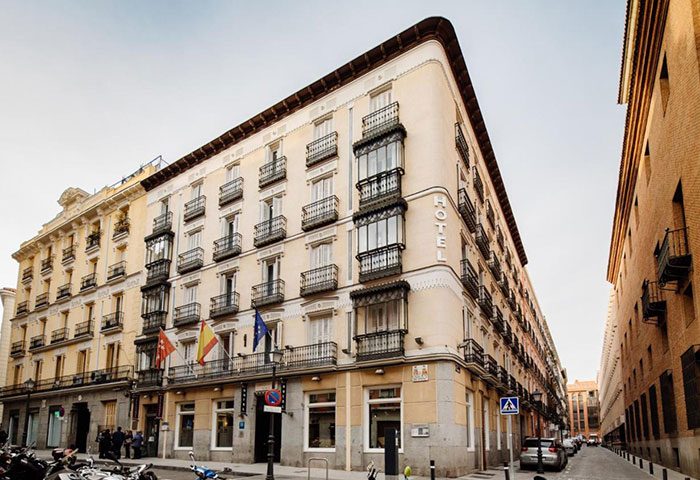Hotel Infantas by MIJ in Madrid's Chueca gayborhood. Building exterior with balconies and flags. Excellent location for gay travelers.