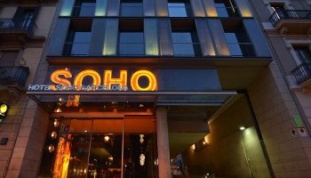 Hotel Soho Barcelona facade at dusk. Excellent location near gay bars. A top choice for gay men visiting Barcelona, Spain.