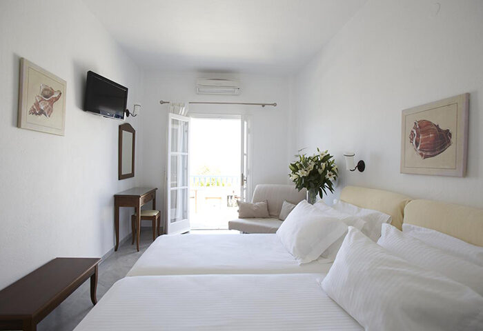 Marisso Hotel, Mykonos Town. Bright room with twin beds, TV, desk, and balcony. Gay hotel with excellent location for gay travelers.