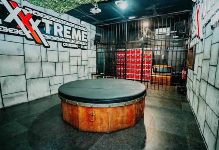 Exxxtreme Cruising Club interior. Gay cruise club with a jail cell theme and a central platform. Gay travel advice for men.