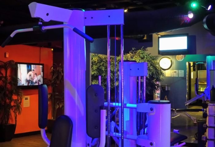 Steamworks gym in Vancouver, Canada. Gay sauna with fitness center, gym equipment, TV screens, and blue lighting. Gay travel advice.