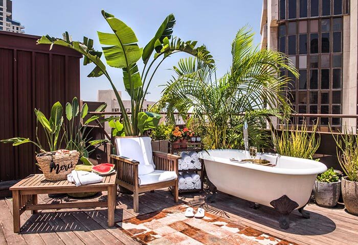 Brown TLV Hotel rooftop bathtub. Gay hotel in Tel Aviv's gayborhood. Luxury travel for gay men. Relaxing vacation.