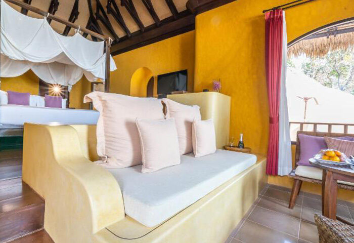 Paradee Resort Koh Samet beachfront suite interior. Luxury gay hotel with bed, daybed, and balcony. Last minute cheap travel deal.