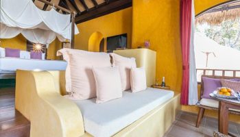 Paradee Resort Koh Samet beachfront suite interior. Luxury gay hotel with bed, daybed, and balcony. Last minute cheap travel deal.