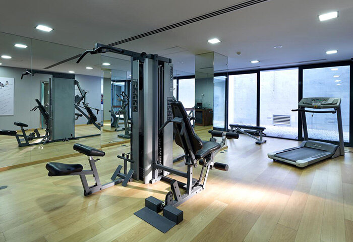 Eurostars Hotel das Letras gym in Lisbon. Luxury gay hotel fitness center with treadmill, weight machines, and mirrors for a complete workout.