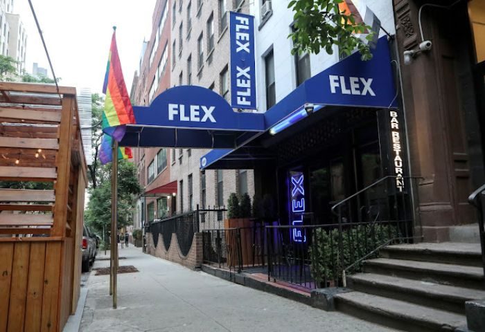 Flex Gay Bar in New York City. Rainbow flags fly outside this popular gay bar and restaurant. A must-visit gay travel destination.